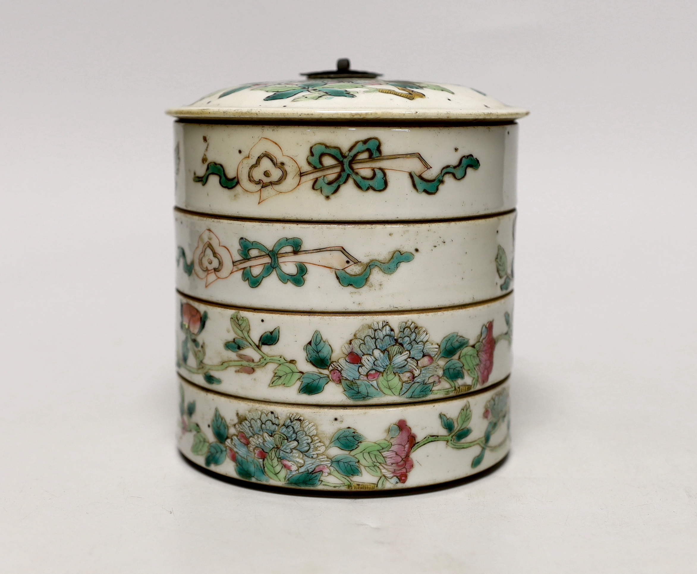 An early 20th century Chinese enamelled porcelain four section stacking food container, with cover 13cm high